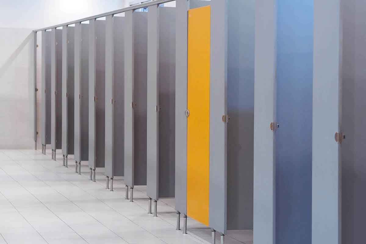 Modern bathroom by Hargreaves Contracting in Lancashire featuring grey cubicles with striking yellow doors.