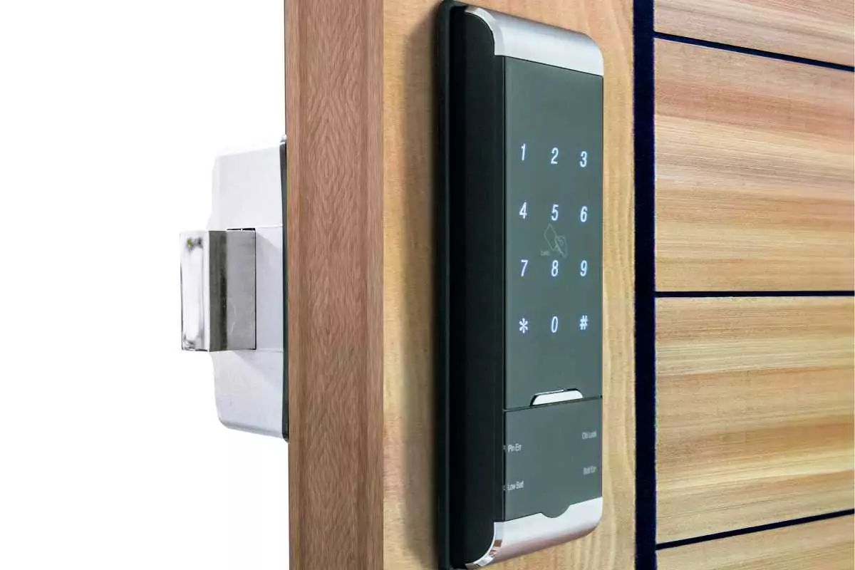Wooden door with a lock and a black number pad with silver accents and white number icons, set against a white background.